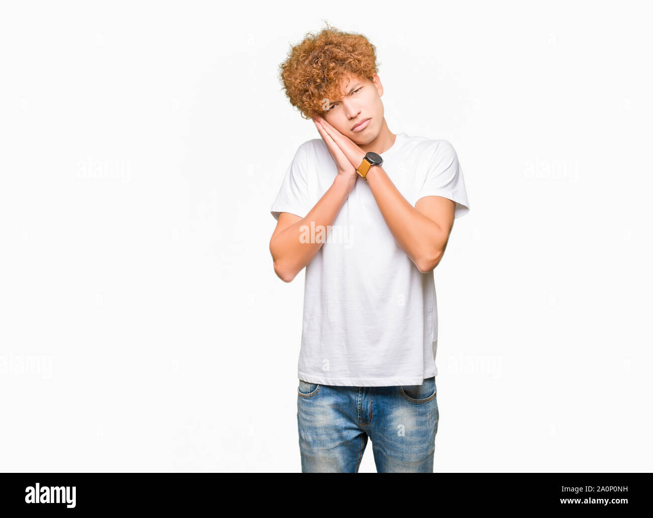 Young handsome man with afro hair wearing casual white t-shirt sleeping ...