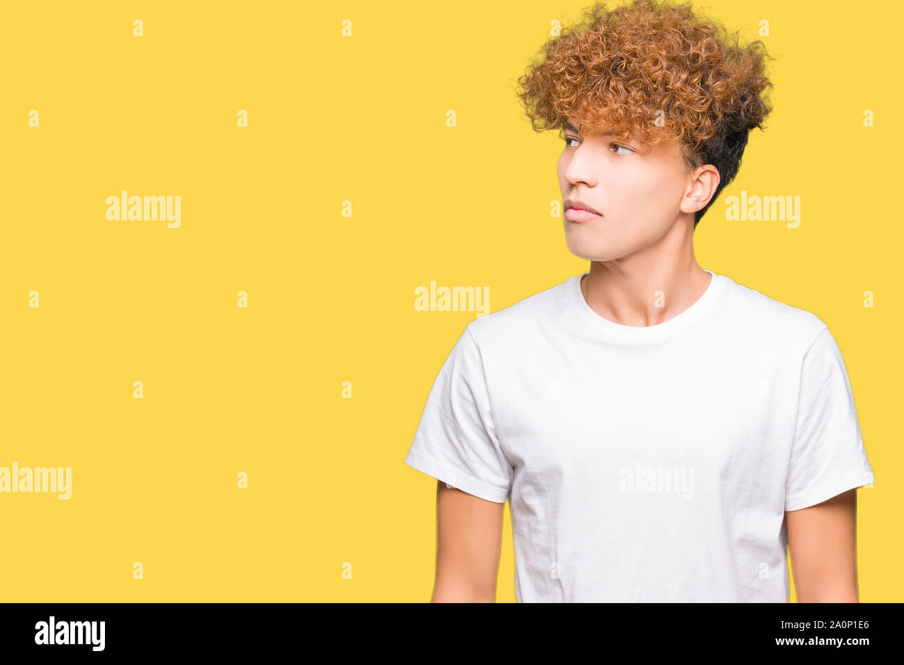 Young handsome man with afro hair wearing casual white t-shirt smiling ...