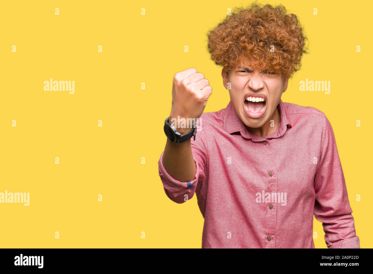 Guy Raging Stock Young handsome business man with afro hair angry and mad raising fist ...
