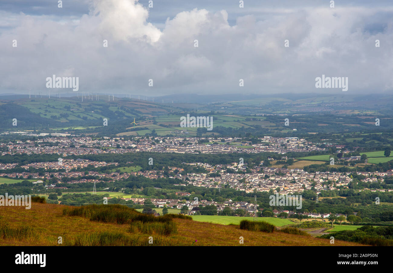 Houses of Llantwit Fardre and Beddau villages are nestled in a valley under Mynydd Maendy hill