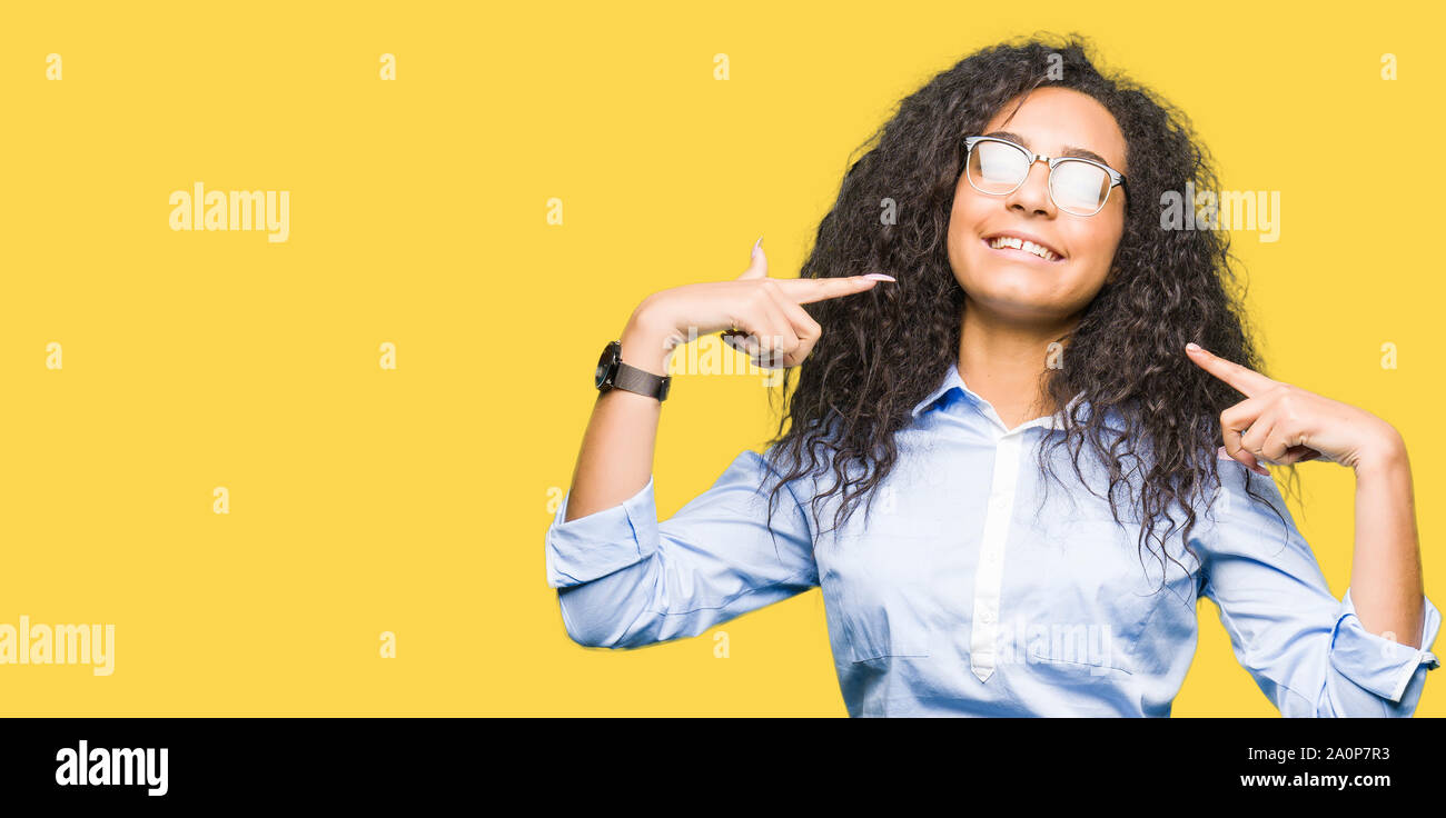 Young beautiful business girl with curly hair wearing glasses smiling ...