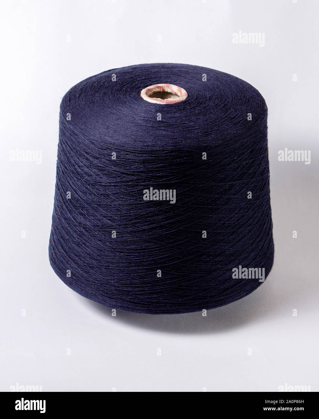bobbin of yarn on a white background. Side view.Textile reel on