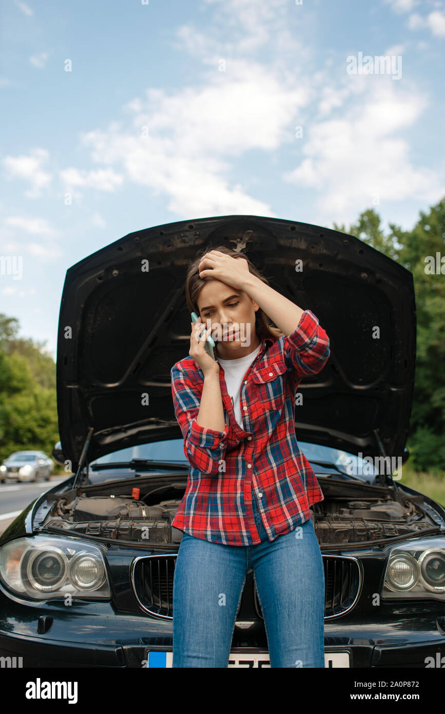 Woman calling a tow truck on road, car breakdown Stock Photo - Alamy