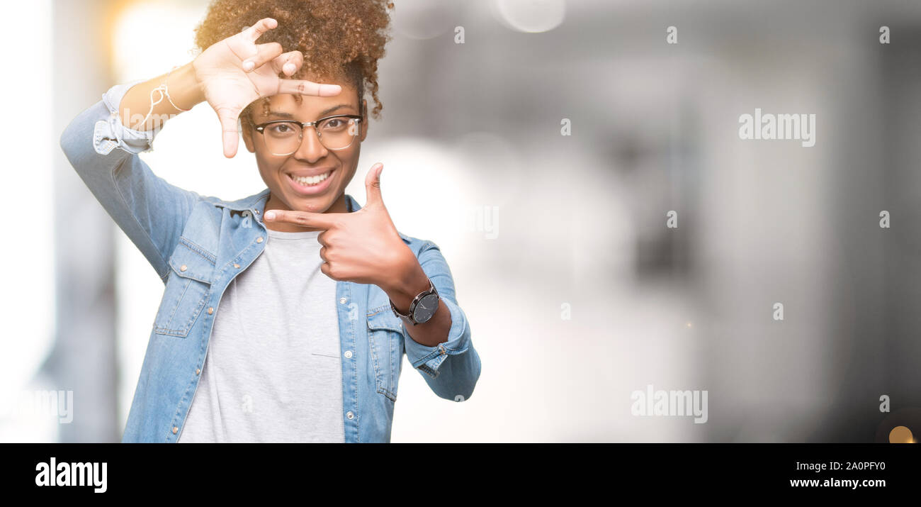 Beautiful young african american woman wearing glasses over isolated ...