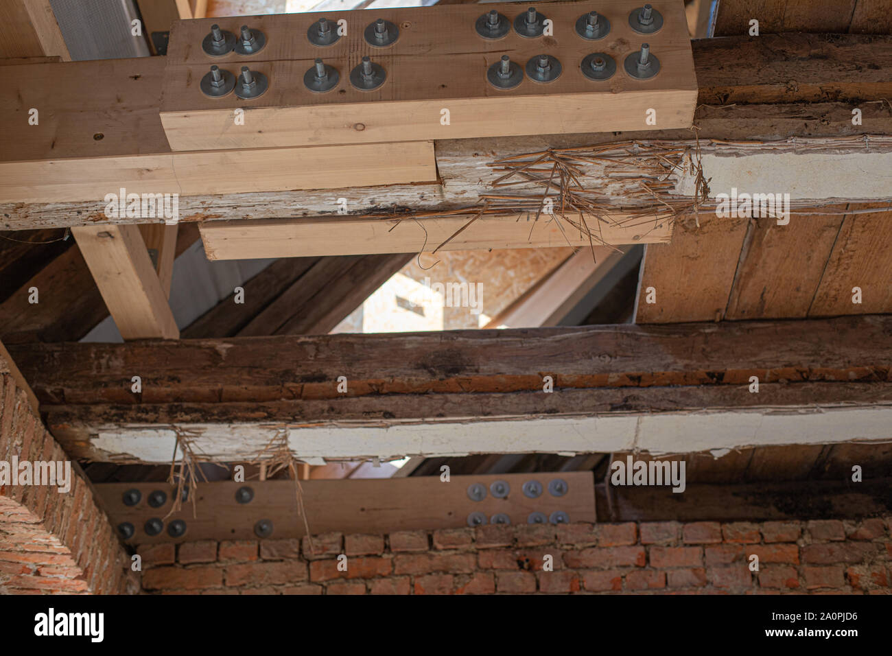 in laborious work an old house is restored, whereby old beams are