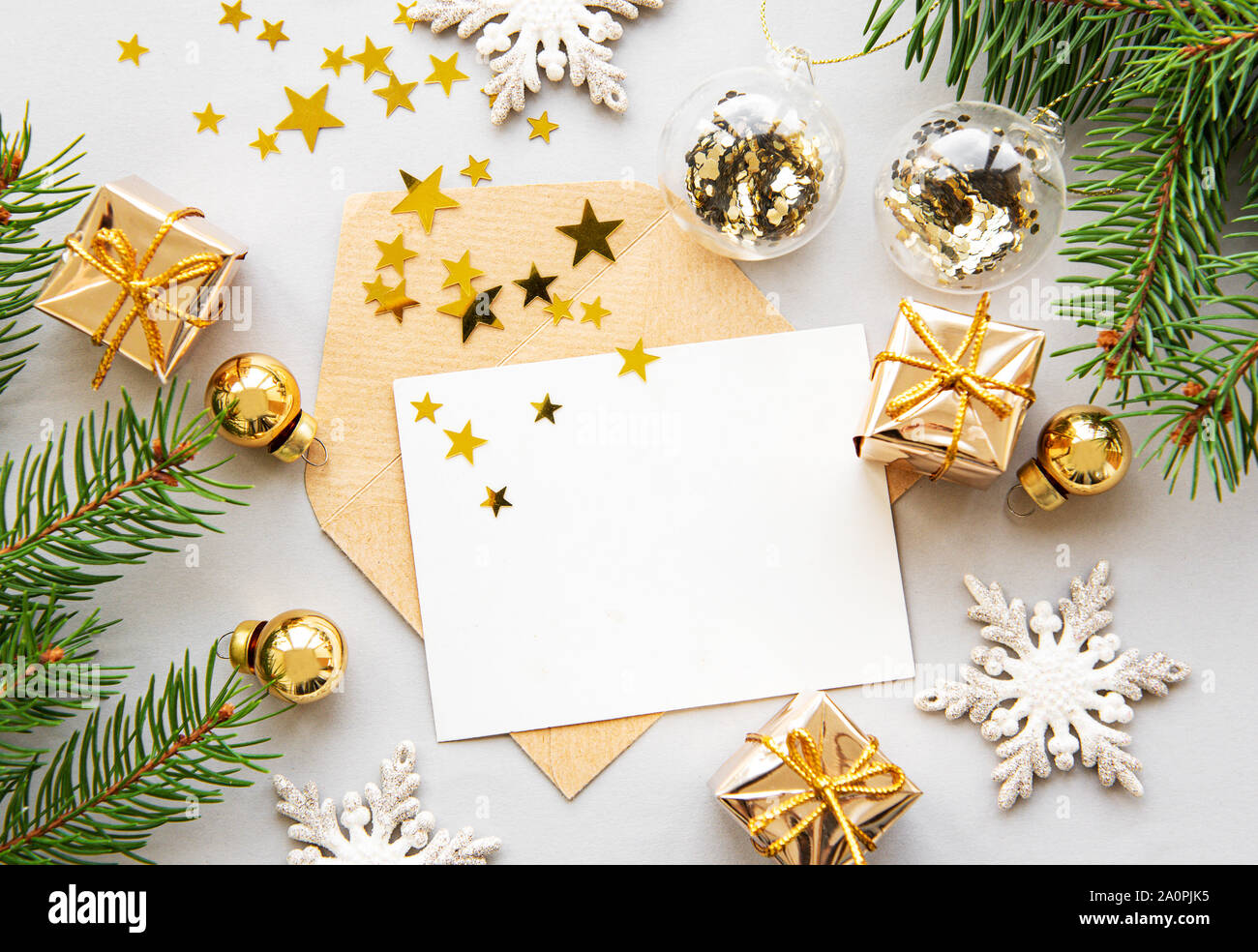 Christmas greeting card with fir tree branches and decorations over ...