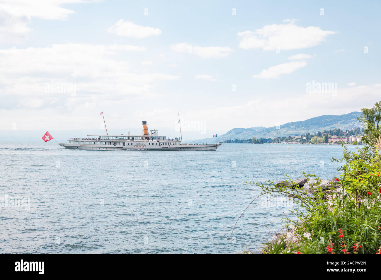 The oldest Belle Epoque steam paddle boat Montreux approaching Swiss Riviera shore in Montreux , Vaud, Switzerland Stock Photo