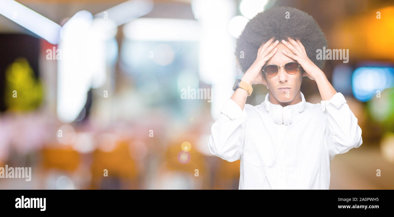 Young african american man with afro hair wearing sunglasses and