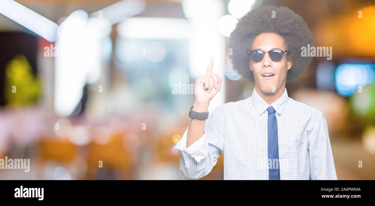 Young african american business man with afro hair wearing sunglasses ...