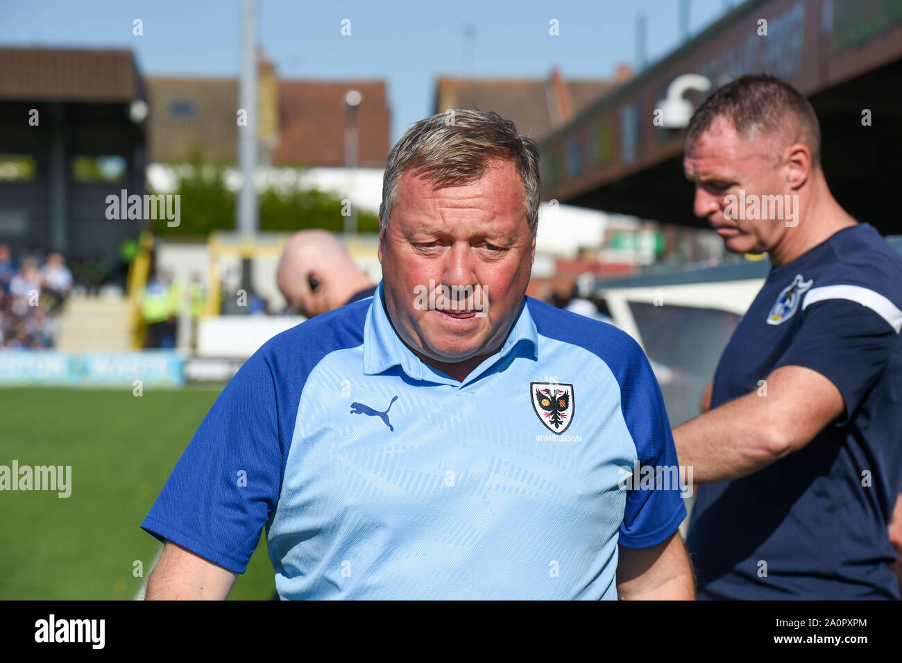 London UK 21 September 2019 - AFC Wimbledon manager Wally Downes with Bristol Rovers manager Graham Coughlan behind during the Sky Bet League One football match between AFC Wimbledon and Bristol Rovers at the Cherry Red Records Stadium - Editorial use only. No merchandising. For Football images FA and Premier League restrictions apply inc. no internet/mobile usage without FAPL license - for details contact Football Dataco . Credit : Simon Dack TPI / Alamy Live News Stock Photo