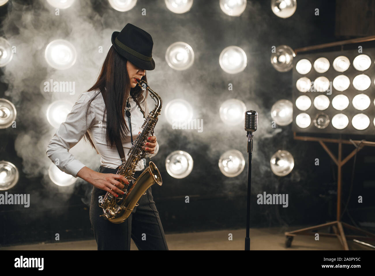 Female jazz musician in hat plays the saxophone Stock Photo - Alamy