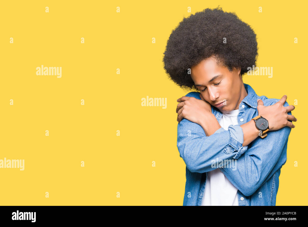 Young African American Man With Afro Hair Hugging Oneself Happy