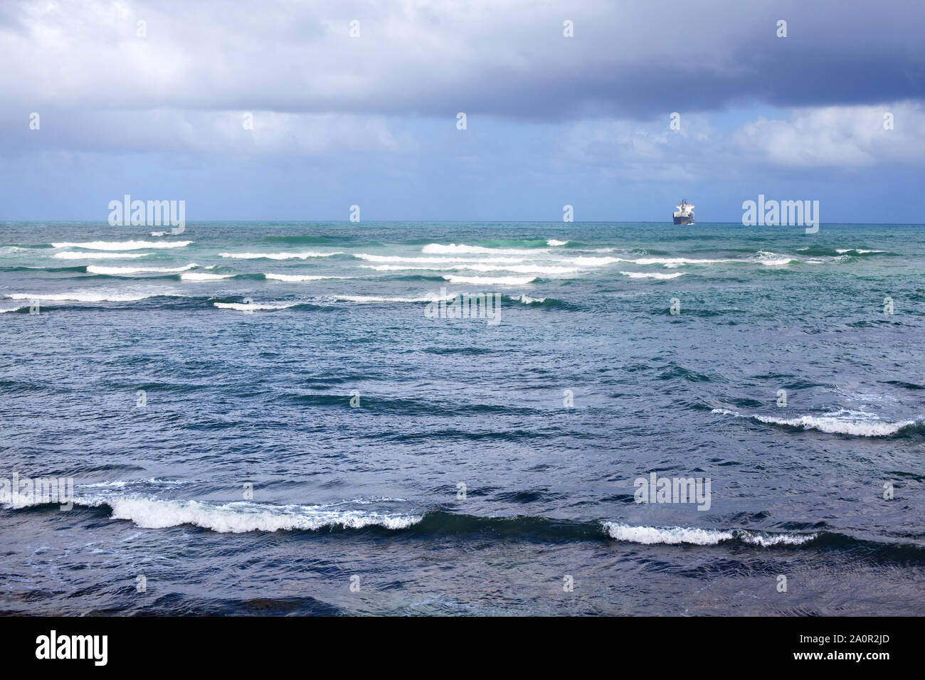 Seascape, ship floating away in the distance on the horizon, stormy sea