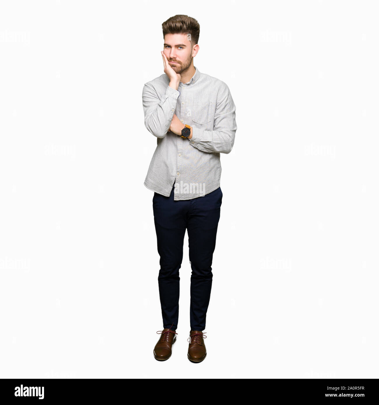 Young handsome man wearing casual shirt thinking looking tired and bored with depression problems with crossed arms. Stock Photo