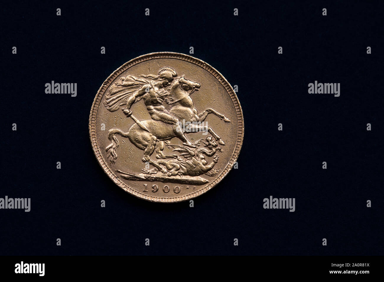 close up of a 1900 Victorian Gold sovereign on a black background showing the reverse side featuring saint George and the dragon Stock Photo