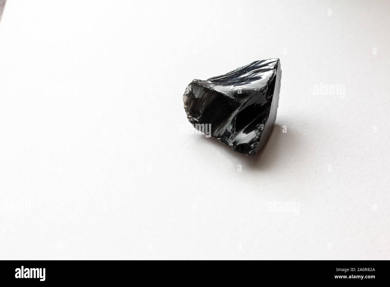 Obsidian on a white background Stock Photo - Alamy