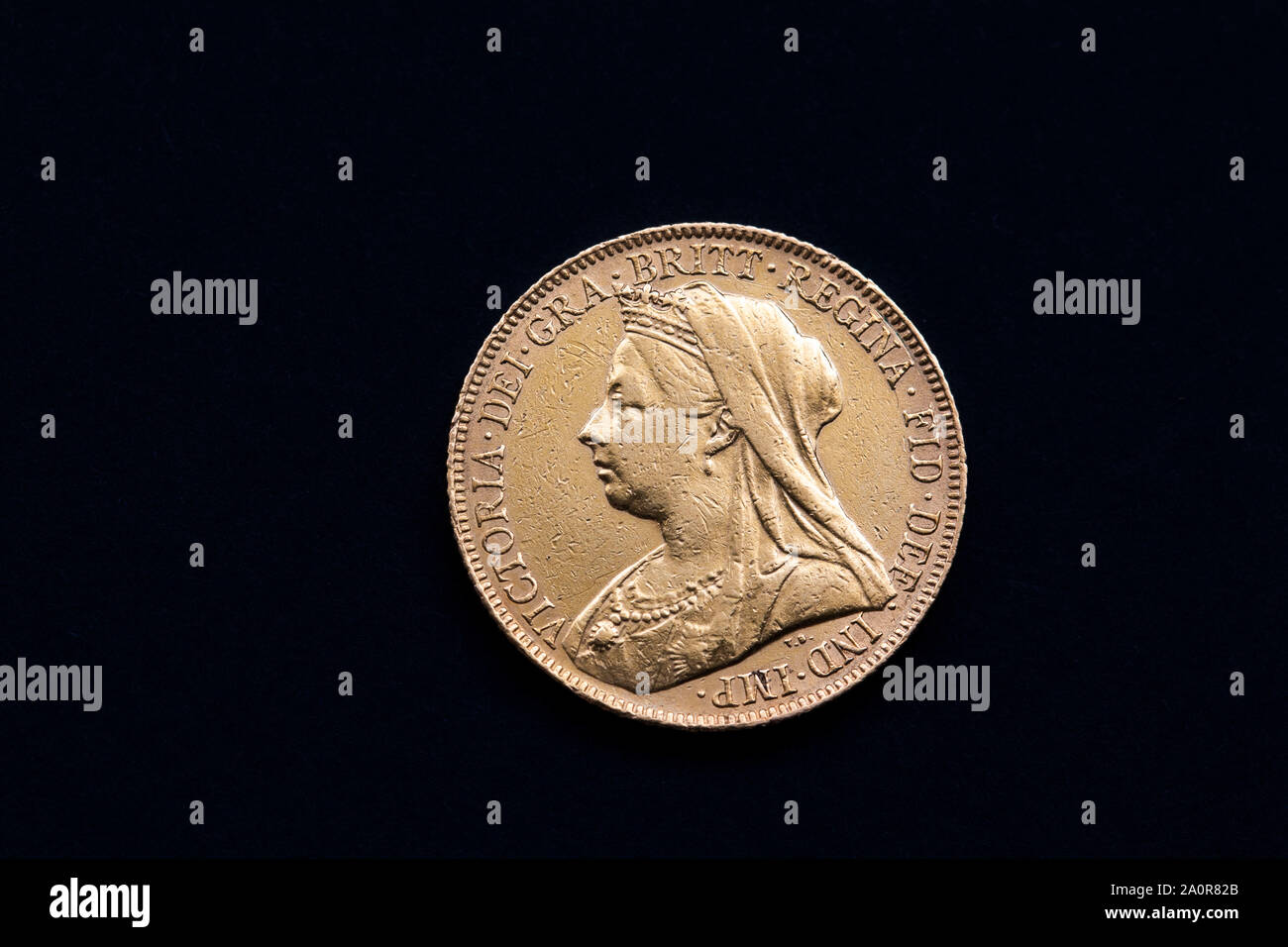 close up of a 1900 Victorian Gold sovereign on a black background showing queen Vicorias head Stock Photo