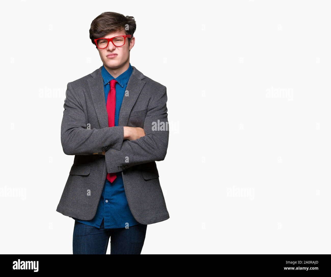 Young handsome business man wearing red glasses over isolated background skeptic and nervous, disapproving expression on face with crossed arms. Negat Stock Photo