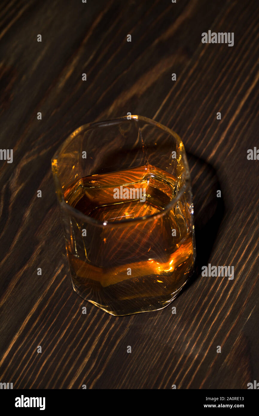 Glass of whiskey served on wooden planks. Stock Photo