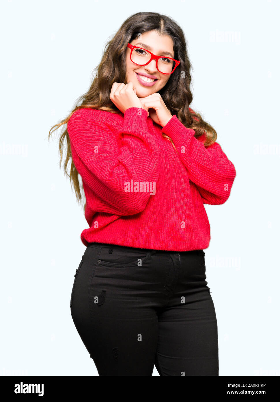 Young beautiful woman wearing red glasses with hand on chin thinking about question, pensive expression. Smiling with thoughtful face. Doubt concept. Stock Photo