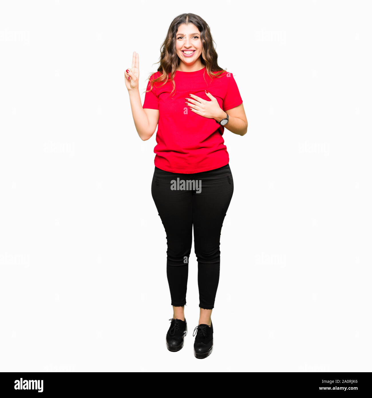 Young beautiful woman wearing casual t-shirt Swearing with hand on chest and fingers, making a loyalty promise oath Stock Photo