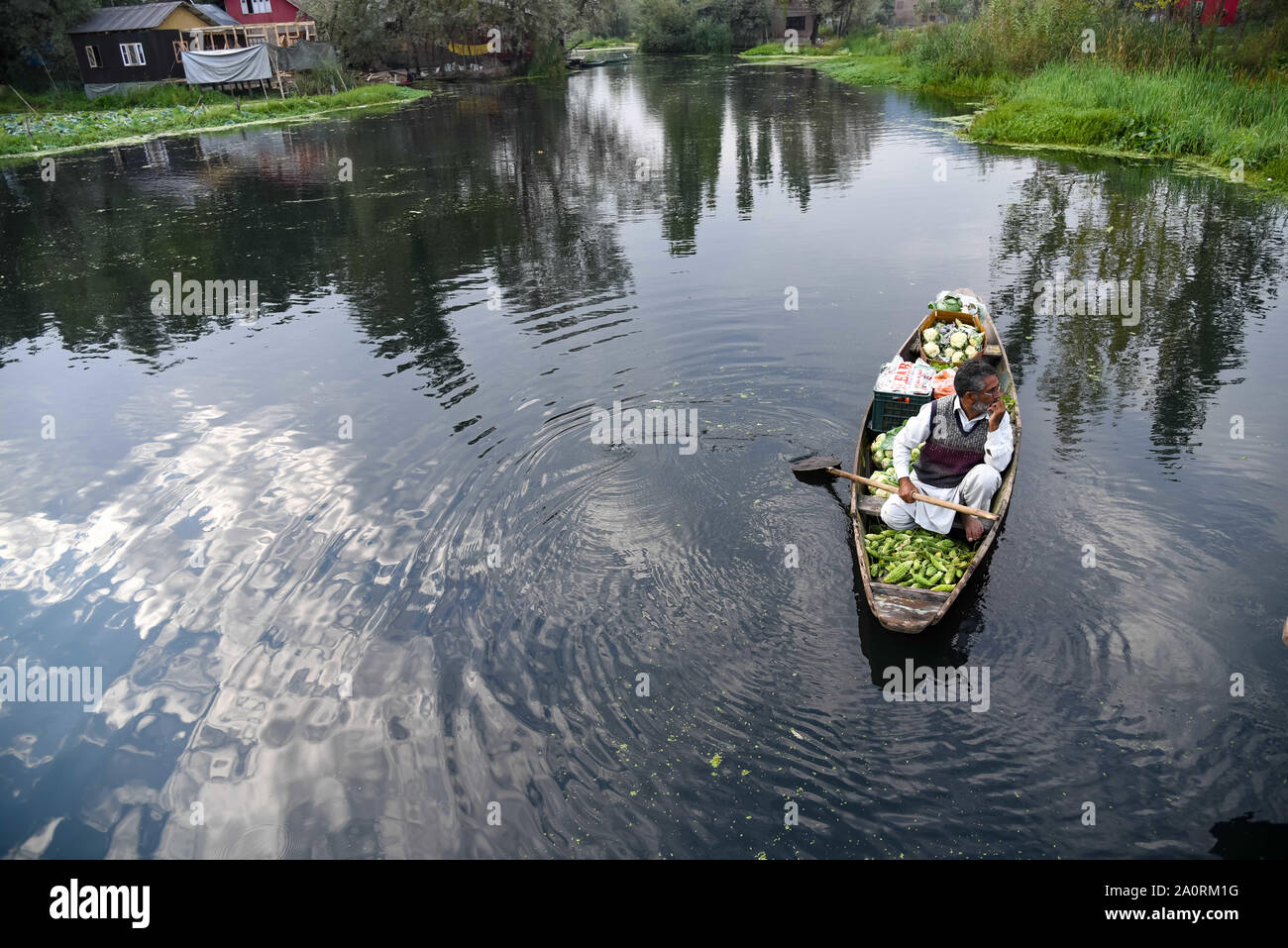 September 21, 2019, Srinagar, Jammu And Kashmir, India: A man on a boat early in the morning in lake Dal during the restrictions in Srinagar..Normal life remains disrupted for the 47th day in Kashmir valley after the abrogation of Article 370 which gives the special status to state. (Credit Image: © Idrees Abbas/SOPA Images via ZUMA Wire) Stock Photo