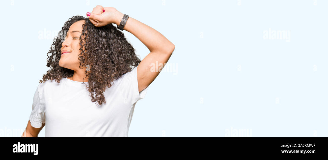 Young Beautiful Woman With Curly Hair Wearing White T Shirt