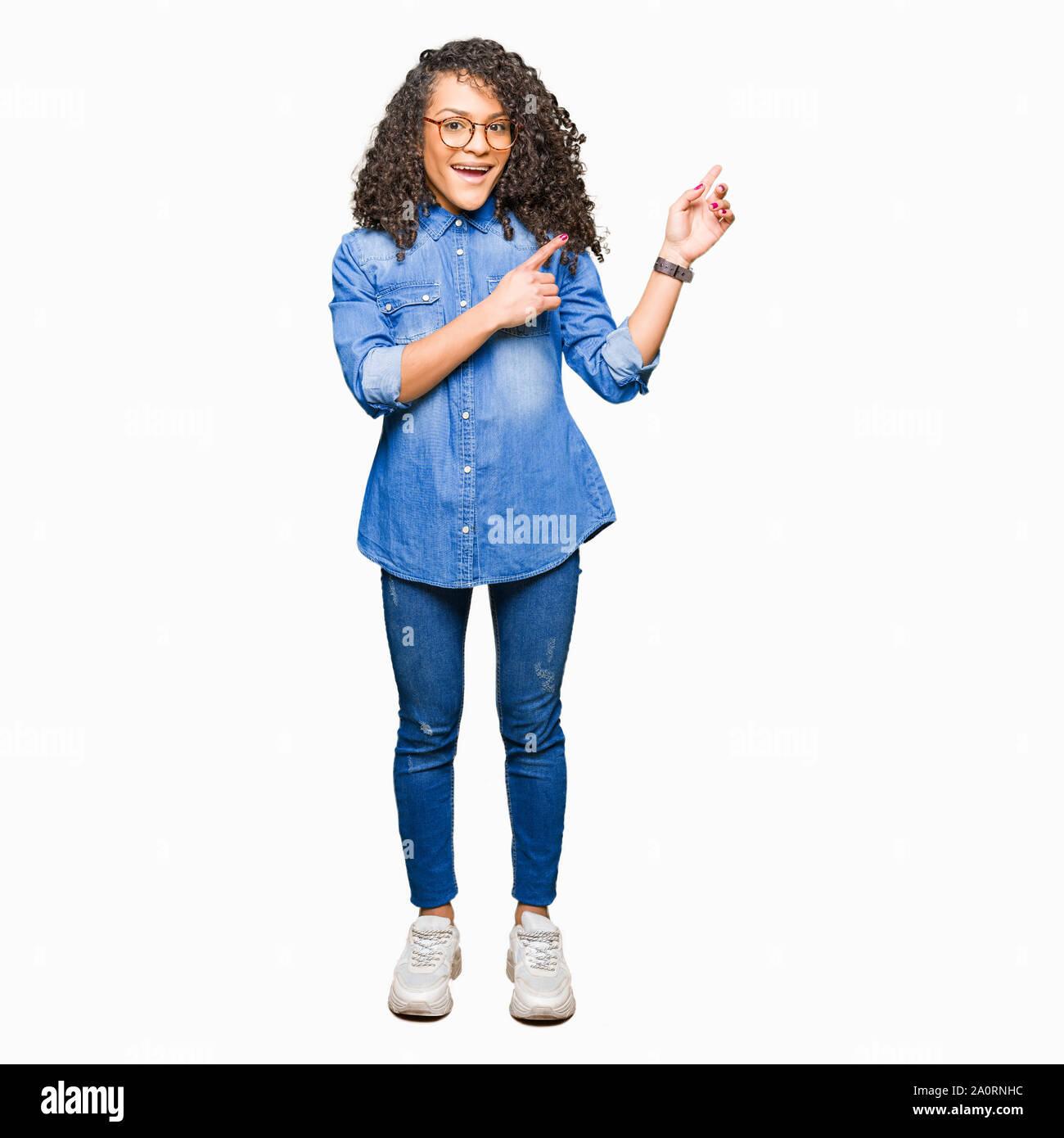 Young beautiful woman with curly hair wearing glasses smiling and ...