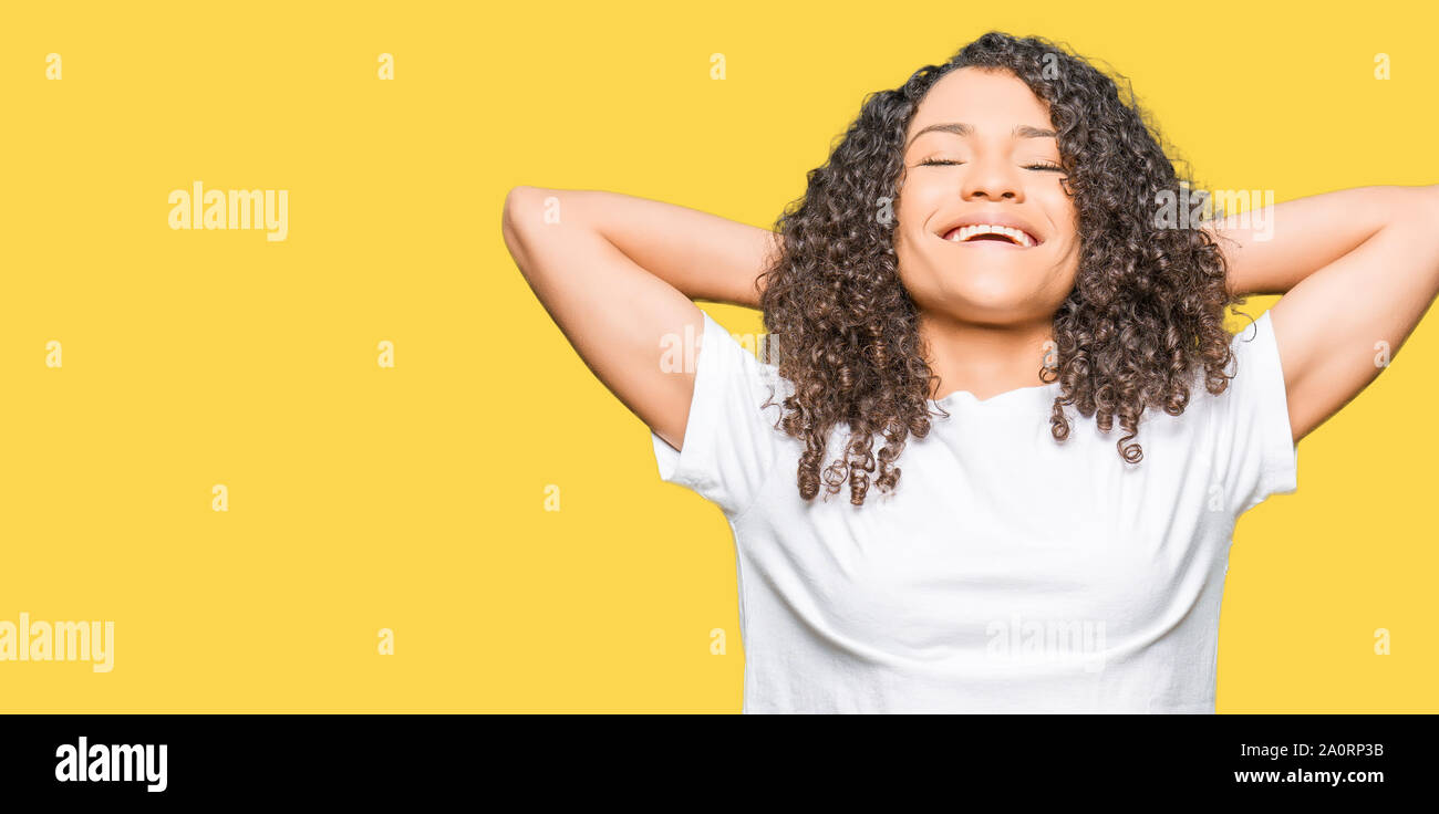 Young Beautiful Woman With Curly Hair Wearing White T Shirt