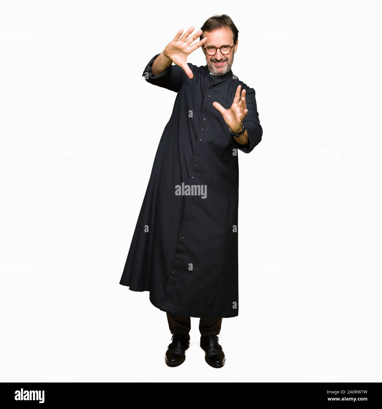 Priest Frame Middle age priest man wearing catholic robe Smiling doing frame using ...