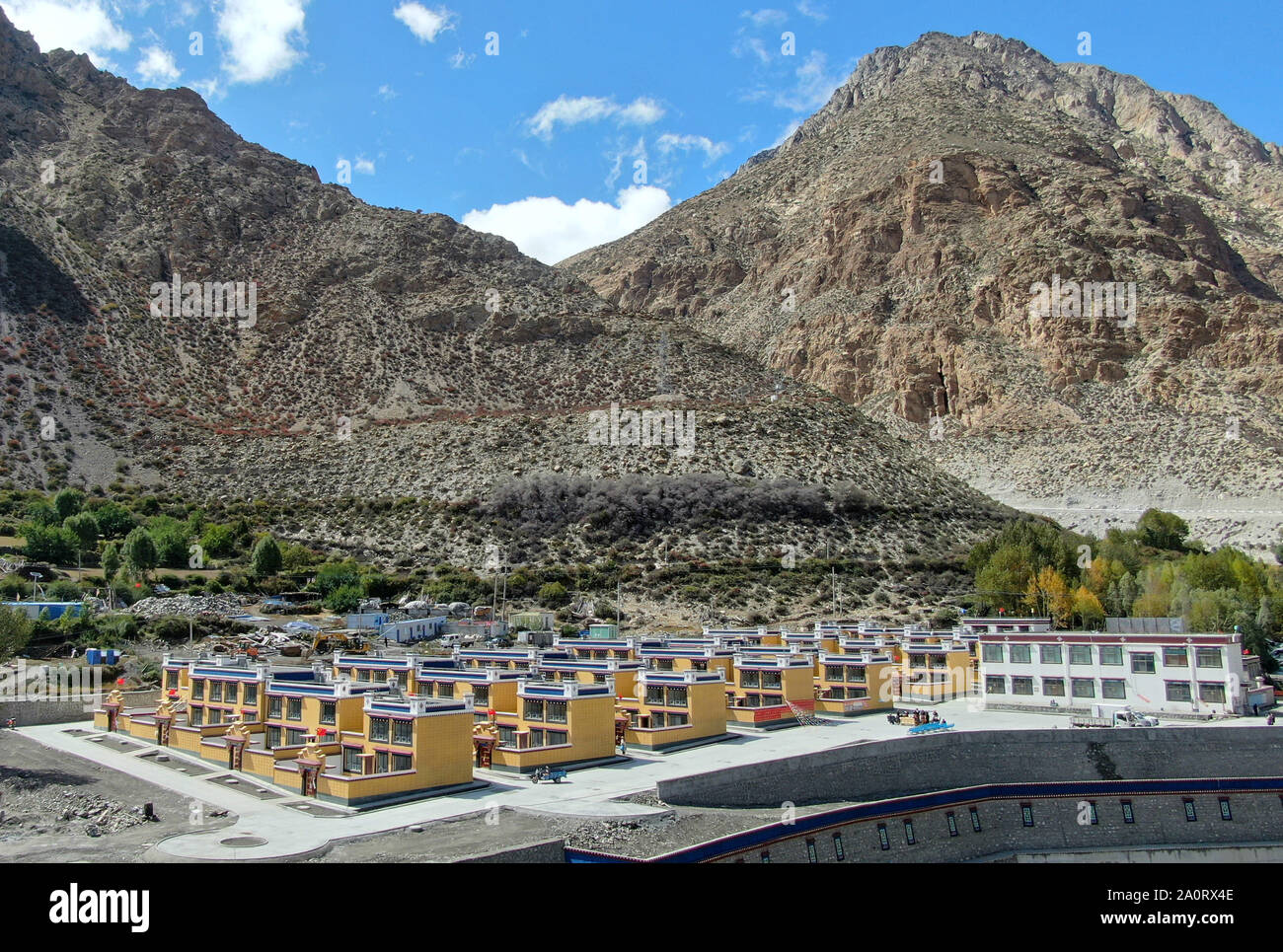 (190921) -- SHANNAN, Sept. 21, 2019 (Xinhua) -- Aerial photo taken on Sept. 21, 2019 shows the government-funded dwellings in Lhozhag Town of Lhozhag County, Shannan City, southwest China's Tibet Autonomous Region. A total of 88 villagers from 28 households moved to their new two-story dwellings to improve housing conditions. (Xinhua/Jigme Dorje) Stock Photo