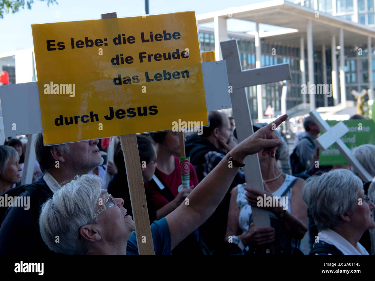 Berlin, Germany. 21st Sep, 2019. A participant from the so-called 'March for Life' holds a sign with the inscription 'Long live: love, joy, life, through Jesus' in the government district. According to the organizer, the association Bundesverband Lebensrecht, the Catholic Church, as well as doctors' and lawyers' associations participated in the 'March for Life'. Hundreds of people demonstrated in Berlin-Mitte against a demonstration by anti-abortion activists. Credit: Paul Zinken/dpa/Alamy Live News Stock Photo