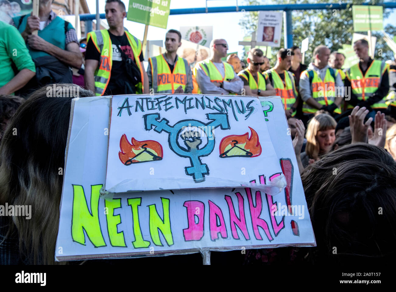 Berlin, Germany. 21st Sep, 2019. Counter-demonstrators have stopped the so-called 'March for Life' with a sit-down blockade and show a sign with the inscription 'Antifeminism No Thank You! According to the organizer, the association Bundesverband Lebensrecht, the Catholic Church, as well as doctors' and lawyers' associations participated in the 'March for Life'. Hundreds of people demonstrated in Berlin-Mitte against the demonstration of anti-abortion activists. Credit: Paul Zinken/dpa/Alamy Live News Stock Photo