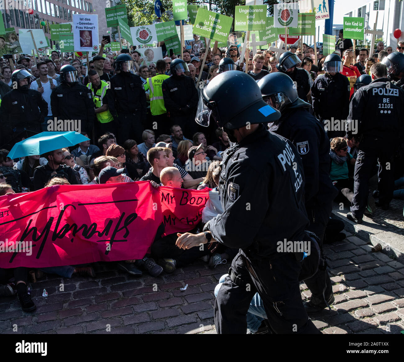 Berlin, Germany. 21st Sep, 2019. Police officers remove a participant of the counter-demonstration after the so-called 'march for life' became a sit-in blockade. According to the organizer, the association Bundesverband Lebensrecht, the Catholic Church, as well as doctors' and lawyers' associations participated in the 'March for Life'. Hundreds of people demonstrated in Berlin-Mitte against the demonstration of anti-abortion activists. Credit: Paul Zinken/dpa/Alamy Live News Stock Photo