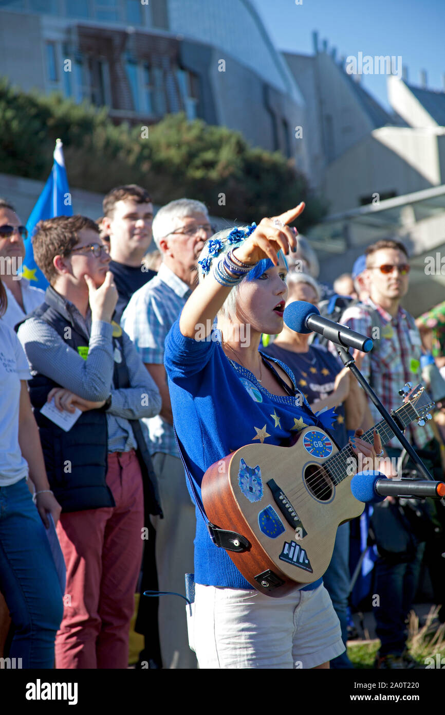 Holyrood Park, Edinburgh, Scotland, UK. 21st September 2019. Rally against Brexit after Royal Mile march, held in Holyrood Park outside Scottish Parliament. Speakers pictured, Madeleina Kay known as #EUsupergirl for her creative campaigning to stop Brexit,who was awarded 'Young European of the Year 2018' by the European Parliament, Stock Photo