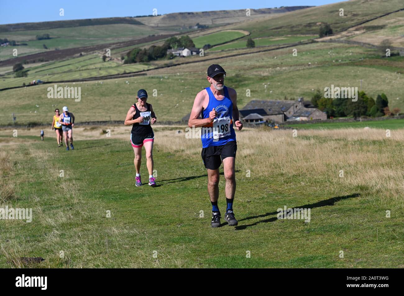 Fell runners in the annual Lantern Pike Race at Little Hayfield, Derbyshire Stock Photo