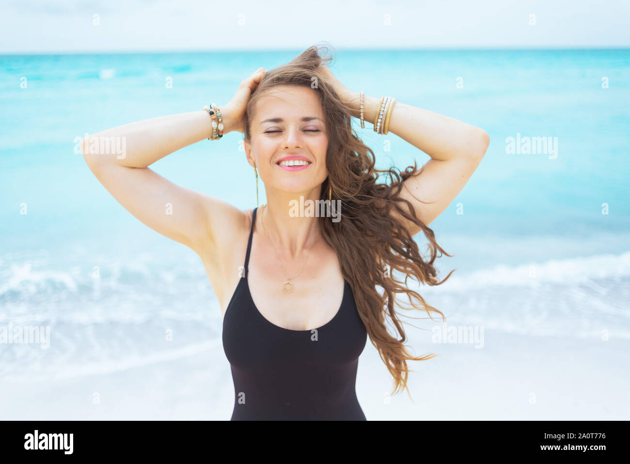 Relaxed Young Middle Age Woman With Long Curly Hair In Elegant