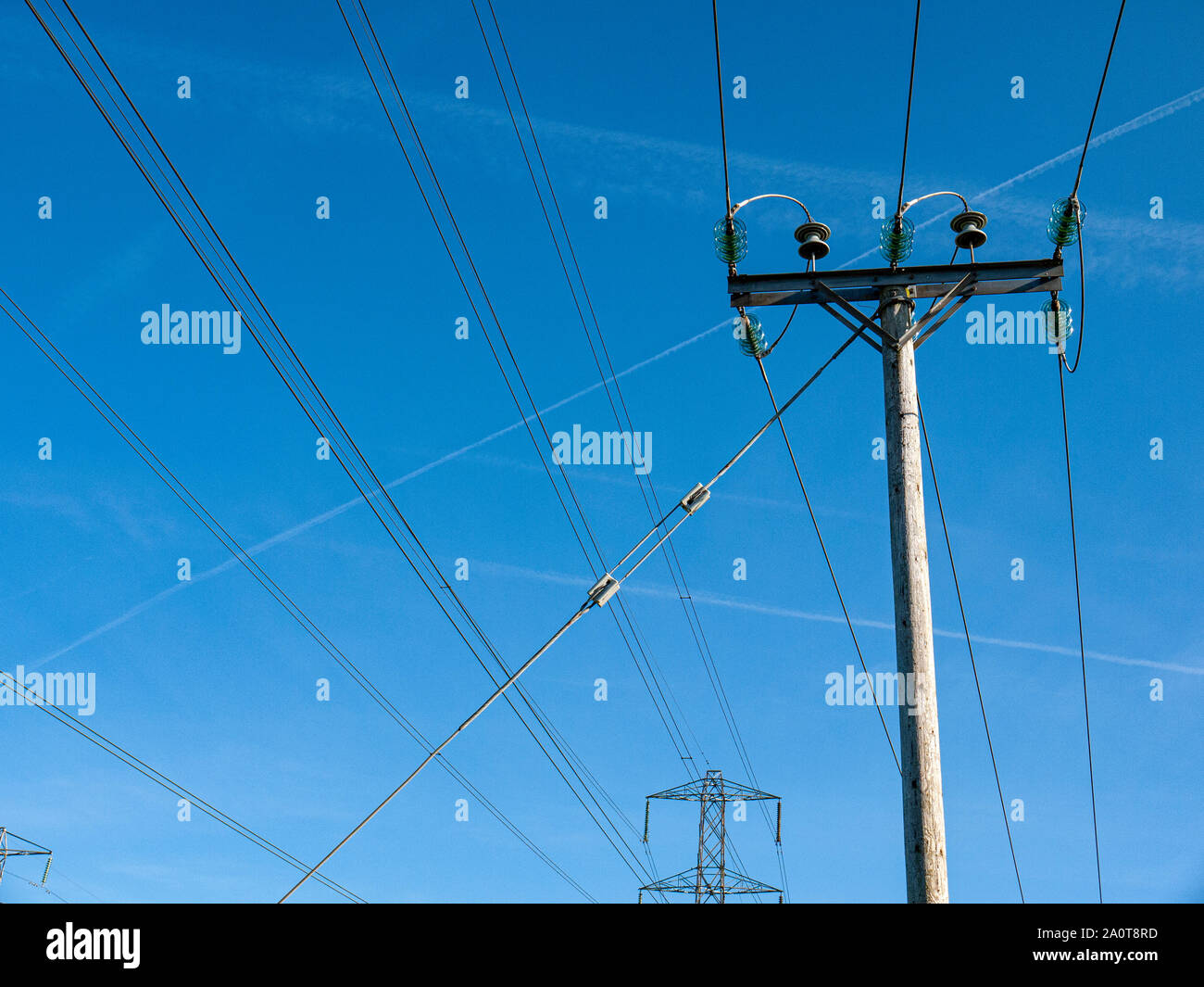 Overhead power cables isolated against blue sky UK Stock Photo Alamy