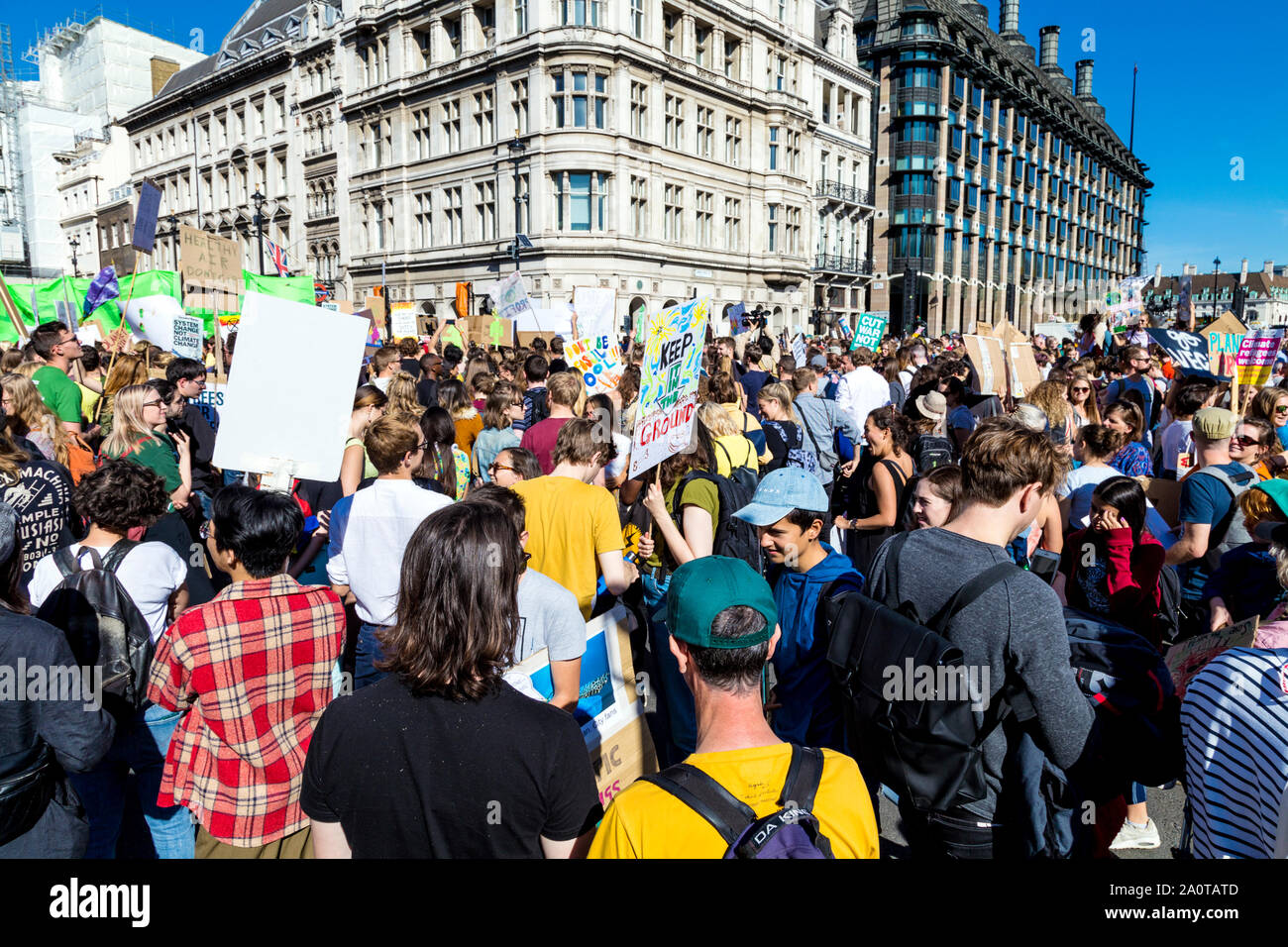 20 September 2019, London, UK - Crowd with signs and placards standing in Parliament Square Garden, Global Climate Strike in Westminster Stock Photo
