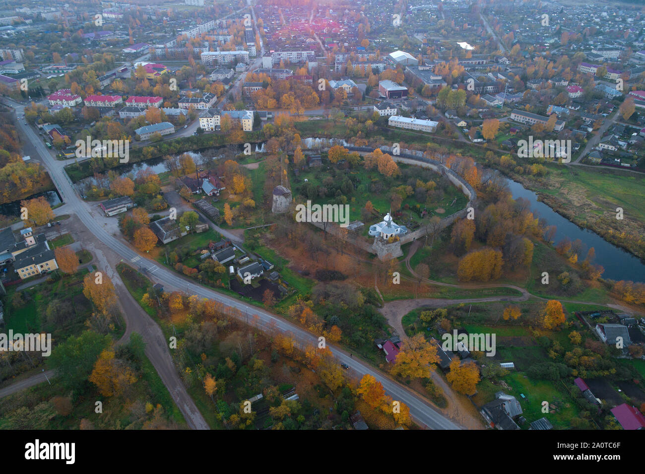 Porkhov fortress in the city panorama in the autumn evening. Porkhov, Russia Stock Photo