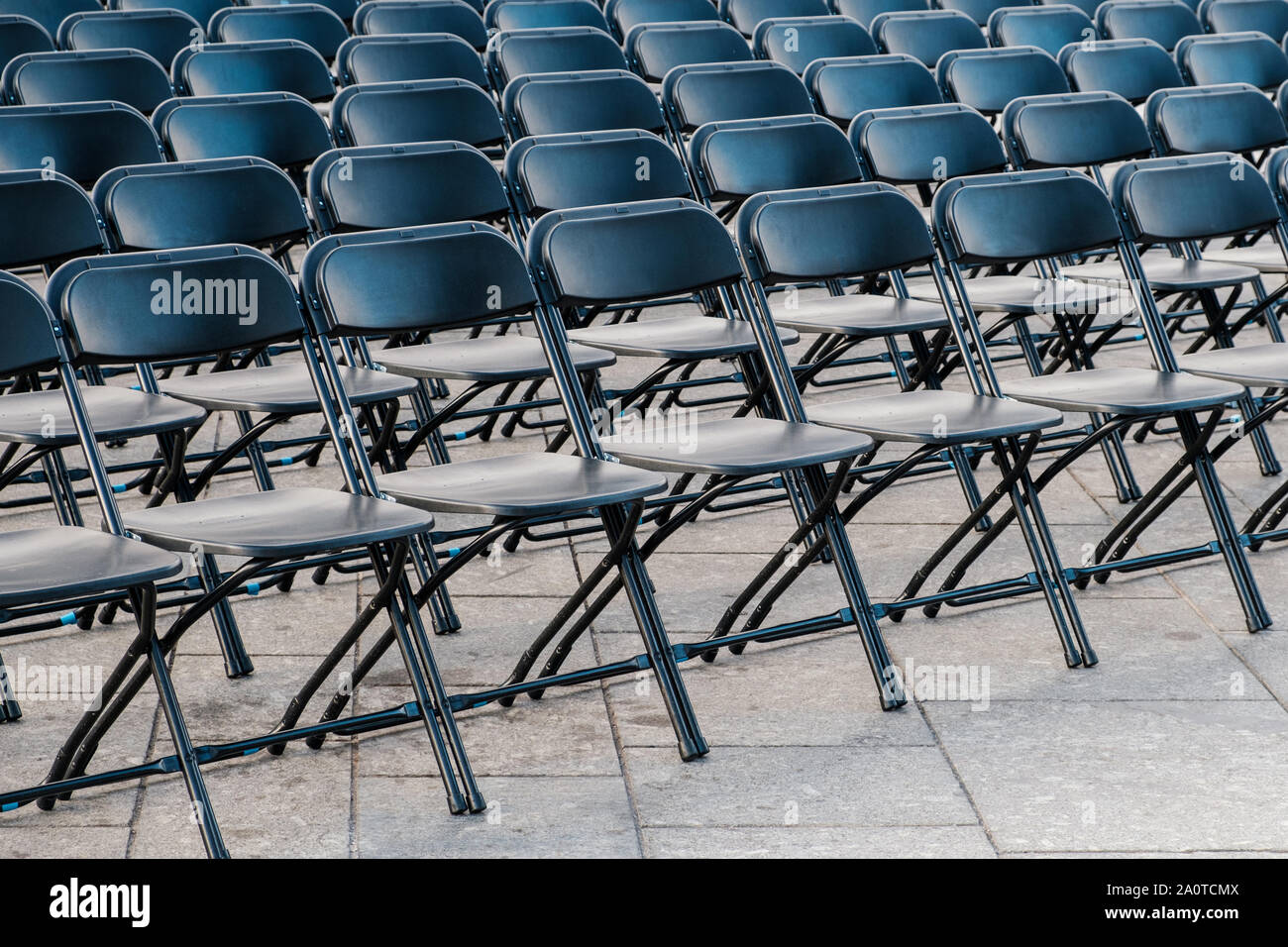 rows of folding chairs, empty seats on event - chair row Stock Photo