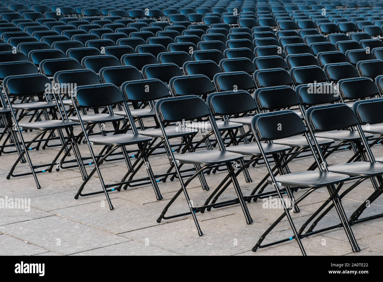 rows of folding chairs, empty seats on event - chair row Stock Photo