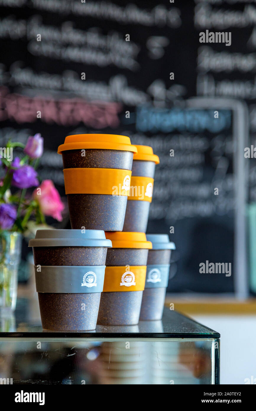Reusable coffee cups for sale at a cafe Stock Photo