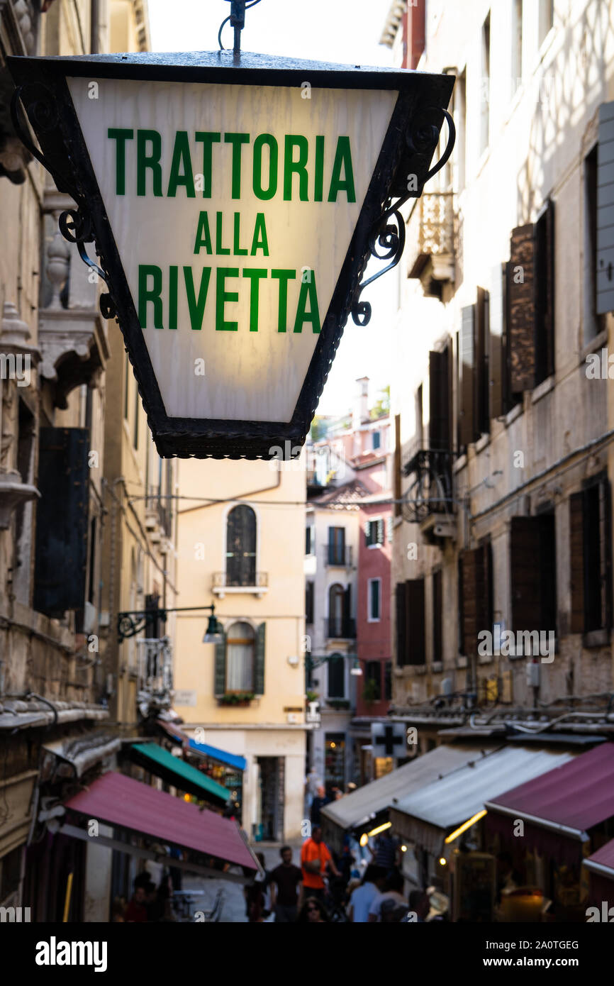 Illuminated trattoria sign (Trattoria alla Rivetta) in a narrow street in  Venice, Italy Stock Photo - Alamy