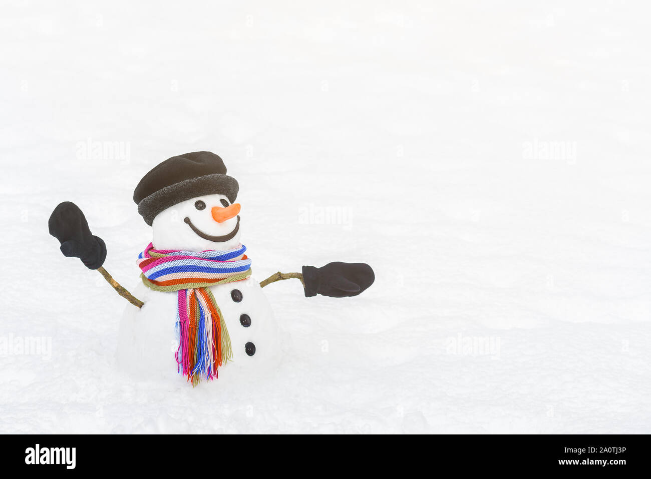 Funny snowman points the way. Snow-white background for text Stock Photo