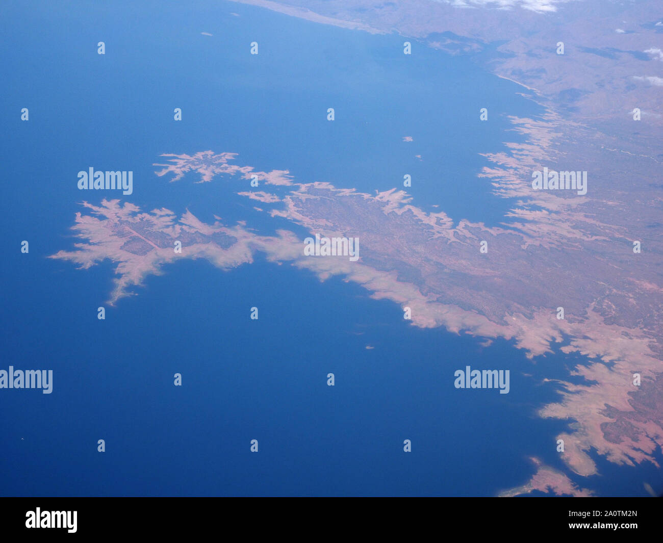 aerial view of Kariba Dam, Zambia,Africa - blue water contrasting with arid flooded shoreline & inlet indentations according to height of terrain Stock Photo