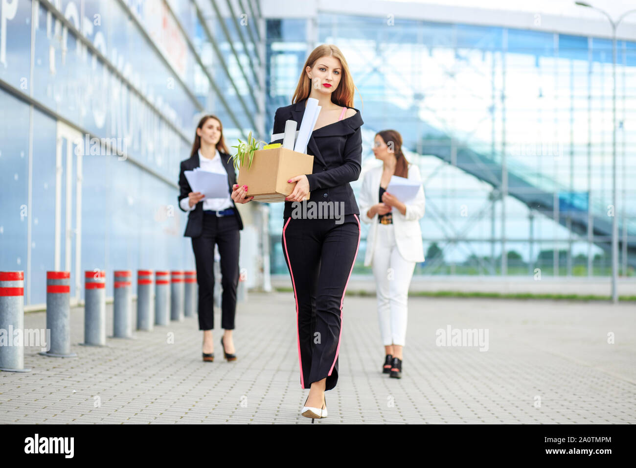 Sad woman fired from a large corporation. The end of a career. Concept for business, unemployment, labor exchange and dismissal. Stock Photo
