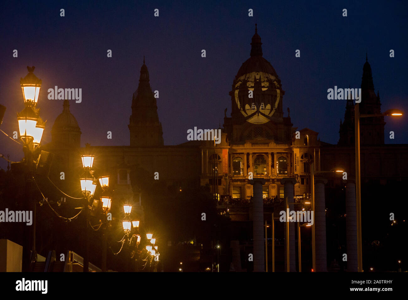 Batman Bat signal appears projected on the facade of the  Palau Nacional de Montjuic in Barcelona on occasion of the character’s 80th anniversary. Stock Photo