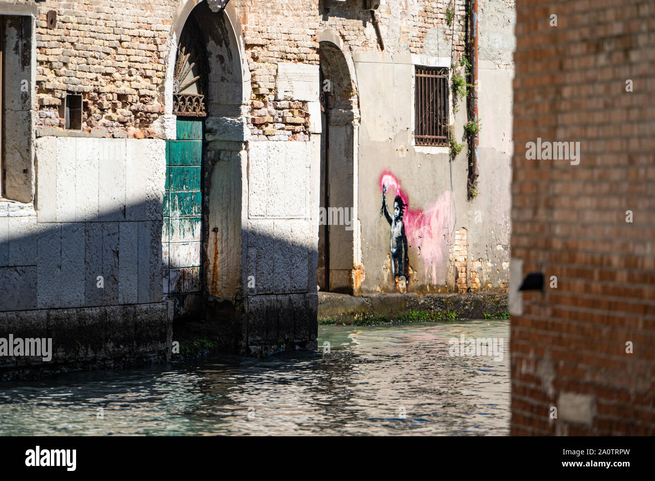 Banksy 'Migrant Child', mural / graffiti / art, Dorsoduro district, Venice, Italy Stock Photo