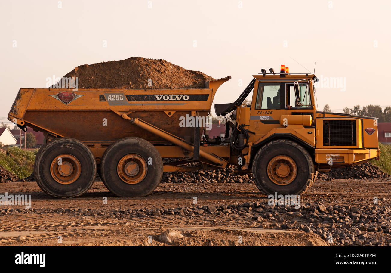 Umea, Sweden - August 28, 2019: big yellow work machine transporting soil for road work Stock Photo